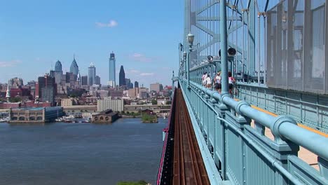 A-group-of-joggers-run-across-the-Ben-Franklin-Bridge-leading-to-Philadelphia-Pennsylvania