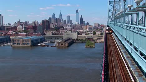 A-rapid-transit-train-drives-across-Ben-Franklin-Bridge-away-from-Philadelphia-Pennsylvania--1