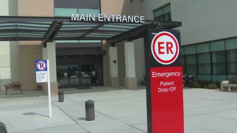 Pan-from-a-hospital-facade-to-an-emergency-room-entrance