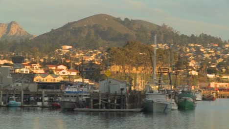 A-pan-across-the-small-Central-California-town-of-Morro-Bay-with-fishing-boats-in-the-harbor
