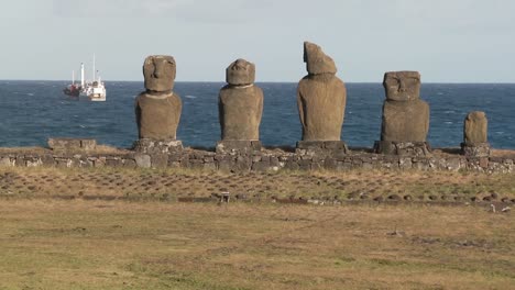 Broken-statues-on-Easter-Island-with-a-boat