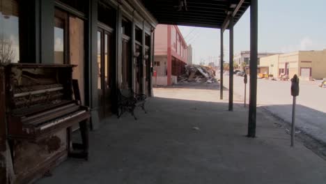 Pan-across-devastated-Galveston-street-after-Hurricane-Ike-and-an-old-piano-sitting-in-front-of-an-abandoned-bar