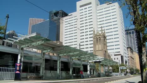 A-rapid-transit-train-moves-quickly-through-downtown-Houston-with-fountains-dancing