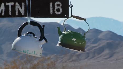 Tea-pots-hang-from-a-sign-in-Death-Valley-National-park