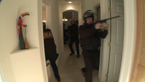 A-SWAT-team-with-DEA-officers-clears-a-house-during-a-drug-raid
