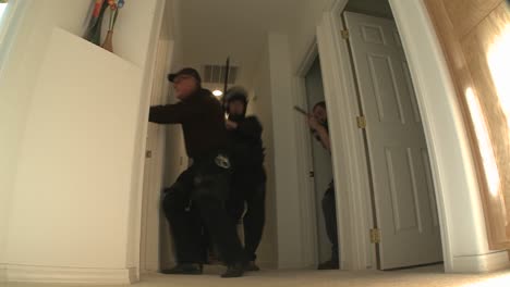 A-SWAT-team-with-DEA-officers-clears-a-house-during-a-drug-raid-1