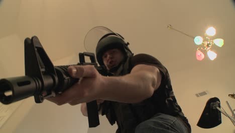 A-SWAT-team-with-DEA-officers-clears-a-house-during-a-drug-raid-and-holds-a-suspect-at-gunpoint-1