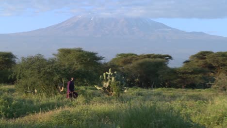 A-Masai-warrior-walks-in-front-of-Mt-Kilimanjaro-in-Tanzania-East-Africa-at-dawn-1