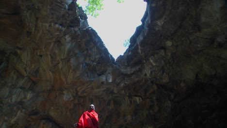 Majestic-shot-of-a-Masai-warrior-standing-in-a-cave-in-Kenya