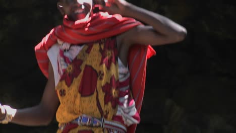 Tilt-up-to-a-Masai-man-speaking-on-a-cell-phone