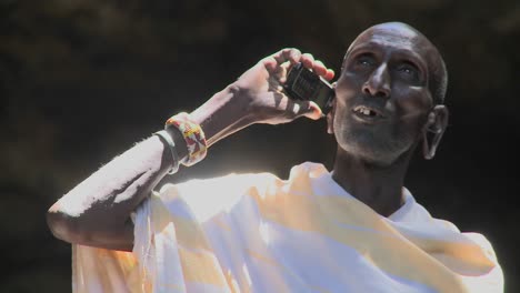 An-old-Masai-man-speaks-to-friends-on-a-cell-phone