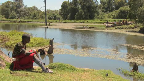 A-young-masai-boy-sits-beside-a-lake-in-Northern-Kenya