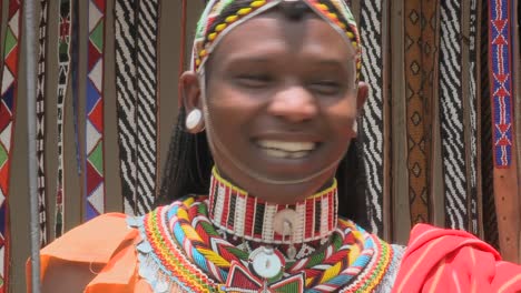 A-smiling-Masai-man-with-beads-and-full-costume