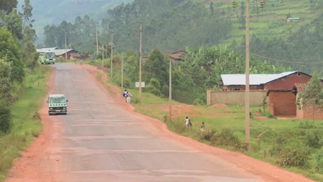 A-minibus-travels-down-a-rural-road-in-Rwanda