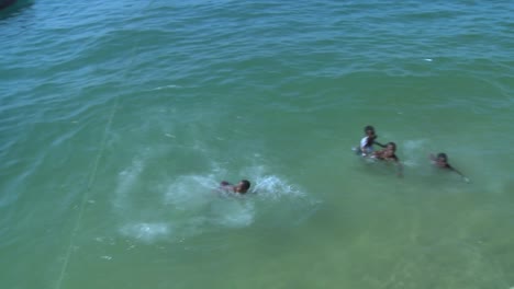African-children-run-and-jump-off-a-dock-at-Stone-Town-Zanzibar