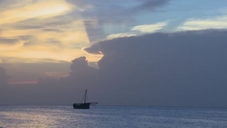 A-distant-boat-sails-along-the-shores-of-Zanzibar-at-sunrise