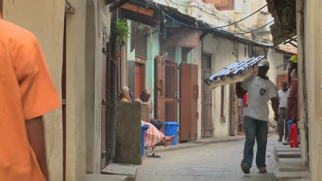 A-sunglasses-vendor-walks-on-the-streets-of-old-Stone-Town-Zanzibar