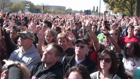 People-wave-their-arms-at-a-giant-outdoor-gathering