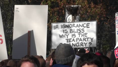 A-sign-is-held-up-about-ignorance-and-the-Tea-Party-at-a-rally-in-Washington-DC