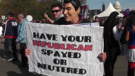 A-man-in-a-Ronald-Reagan-mask-urges-people-to-have-their-Republican-spayed-or-neutered