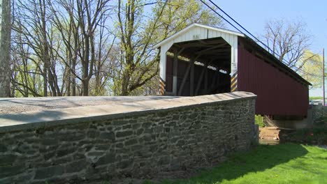 An-Amish-horse-and-buggy-cart-pass-through-a-covered-bridge-in-rural-Lancaster-Pennsylvania