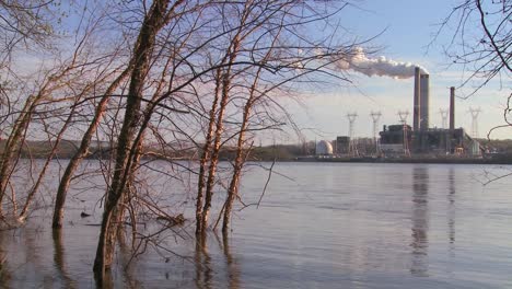 A-power-plant-with-smokestacks-near-a-river