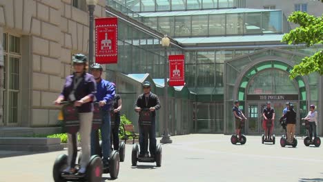 People-ride-segways-in-an-outdoor-area