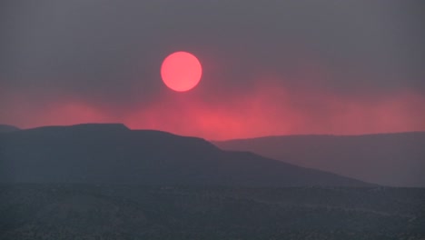 Time-lapse-shot-as-the-sun-sets-behind-a-smoky-red-horizon