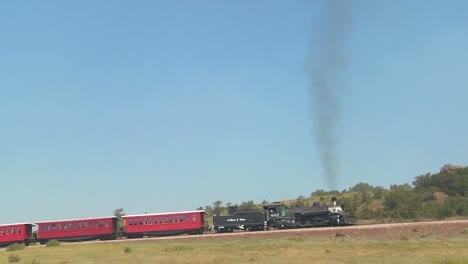 Panning-shot-of-a-steam-train-across-a-bluff
