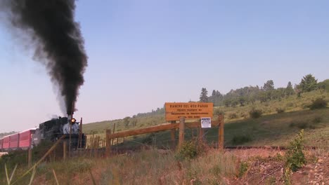 A-steam-train-approaches-a-grade-crossing