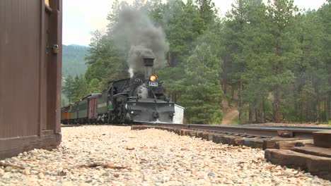 We-move-up-on-a-steam-train-passing-a-depot-in-this-classic-Western-shot