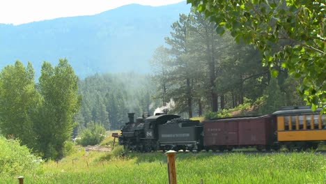 A-steam-train-moves-travels-through-the-countryside-in-the-Rocky-Mountains