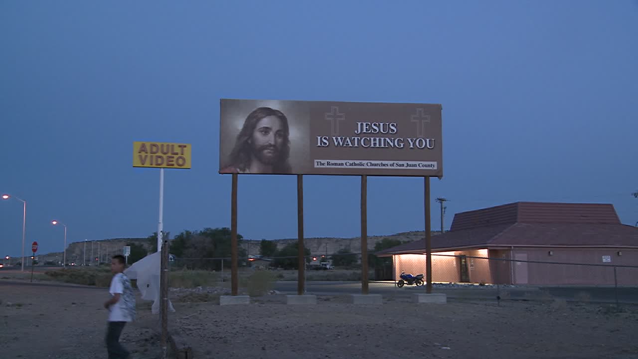 A Billboard Advertising Jesus Is Watching You Near An Adult Video Store  Free Stock Video Footage Download Clips Religion