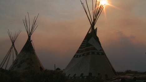 Indian-teepees-stand-in-a-native-american-encampment-at-sunset-1