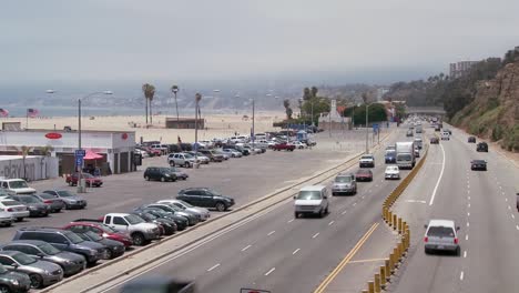 Follow-shot-up-from-car-driving-on-Highway-101-to-reveal-the-Santa-Monica-beach