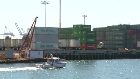 A-harbor-boat-passes-beside-Long-Beach-harbor-and-shipping-containers