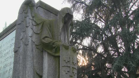 A-ghostly-angel-looks-down-on-a-grave-from-above