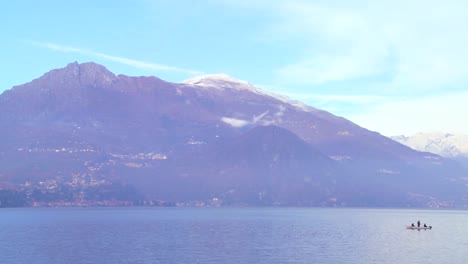 A-fishing-boat-on-the-shores-of-Lake-Como-with-the-Italian-Alps-in-background