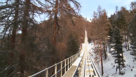 Time-lapse-POV-from-the-front-of-a-cable-car-going-up-a-snow-covered-mountain