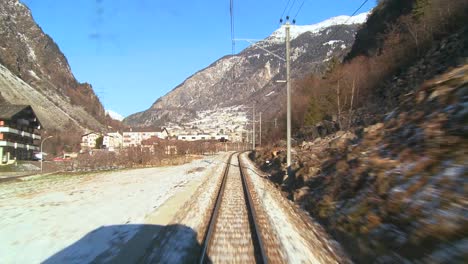 A-POV-shot-from-the-front-of-a-train-moving-through-a-mountainous-region