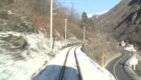A-time-lapse-POV-shot-from-the-front-of-a-train-moving-through-a-mountainous-region