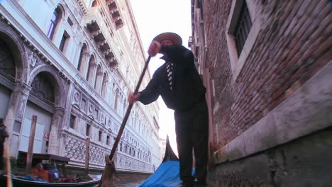 A-nice-shot-of-a-gondolier-rowing-a-gondola-under-a-bridge-in-Venice-Italy-2