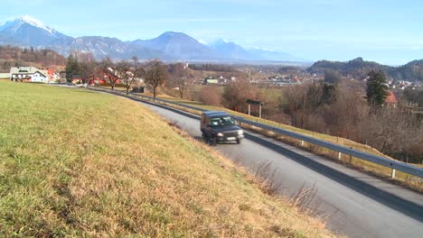 Cars-drive-through-the-countryside-of-Slovenia-or-an-Eastern-European-nation