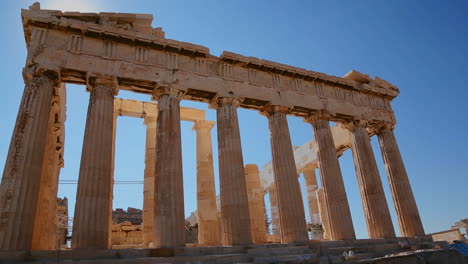 Low-angle-shot-of-the-columns-of-the-Acropolis-and-Parthenon-on-the-hilltop-in-Athens-Greece
