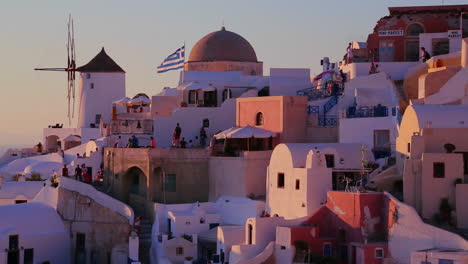 White-buildings-and-windmills-line-the-hillsides-of-the-Greek-Island-of-Santorini-at-dusk-3