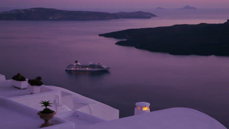 A-cruise-ship-moves-through-the-Greek-Isles-in-purple-light-at-dusk