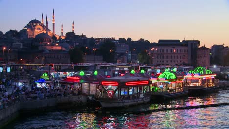Colorful-boats-at-dusk-in-front-of-a-mosque-in-Istanbul-Turkey