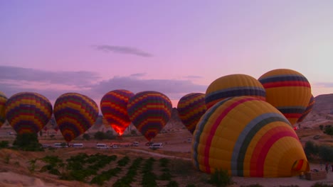 Time-lapse-shot-of-hot-air-balloons-firing-up-at-dawn