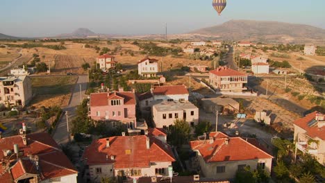 Hot-air-balloons-fly-over-a-neighborhood-near-Cappadocia-Turkey-1