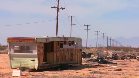 An-abandoned-trailer-sits-in-the-middle-of-the-Mojave-desert